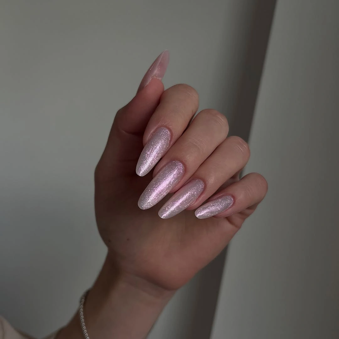 Long pink almond nails with luminous metallic shimmer