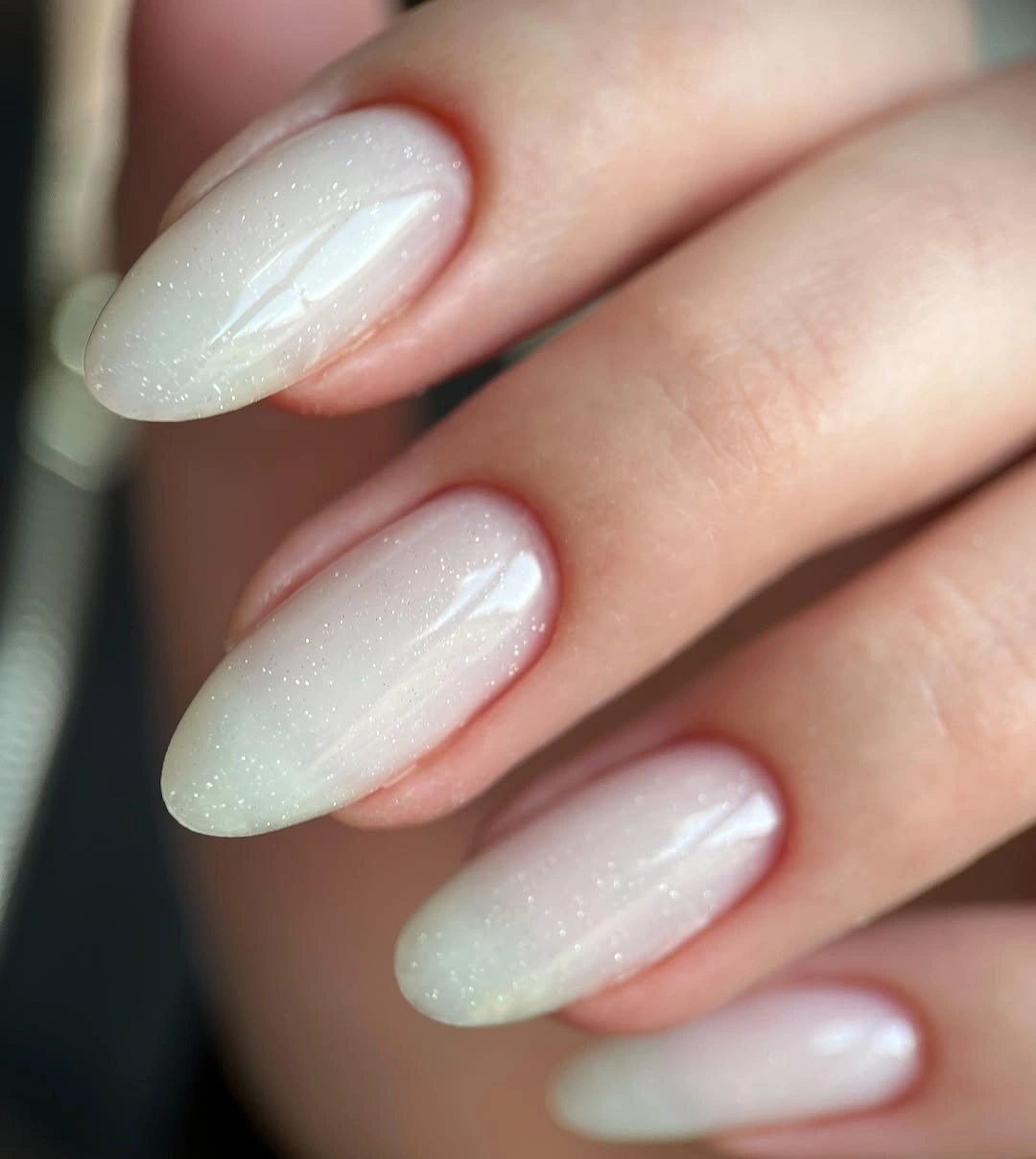 Milky almond nails with tiny iridescent sparkle