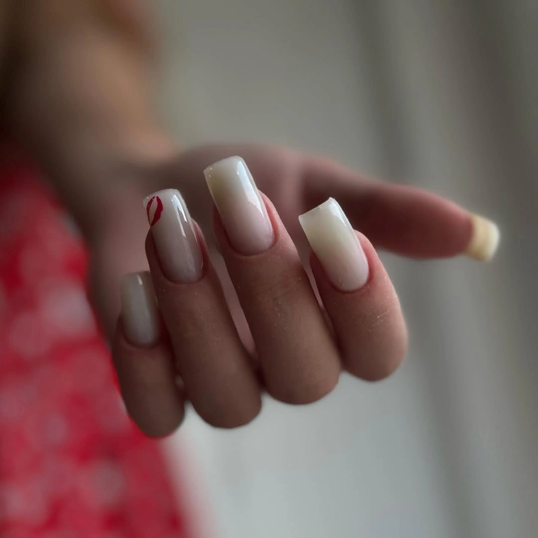 Milky square nails with one small red accent