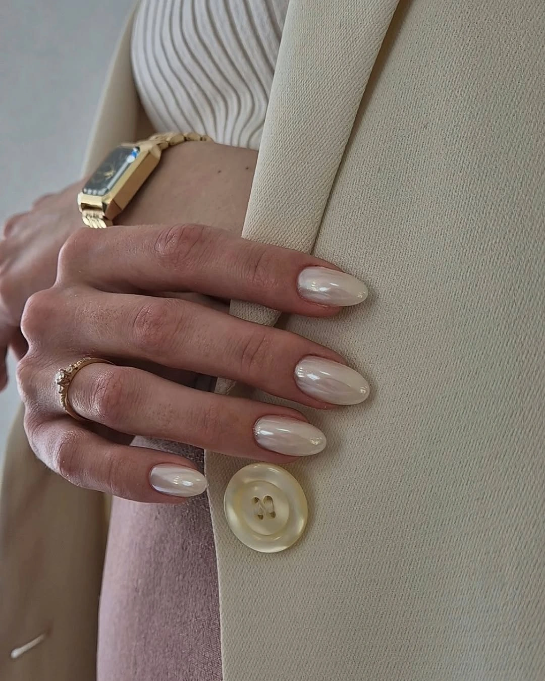Creamy pearl white almond nails with glossy sheen