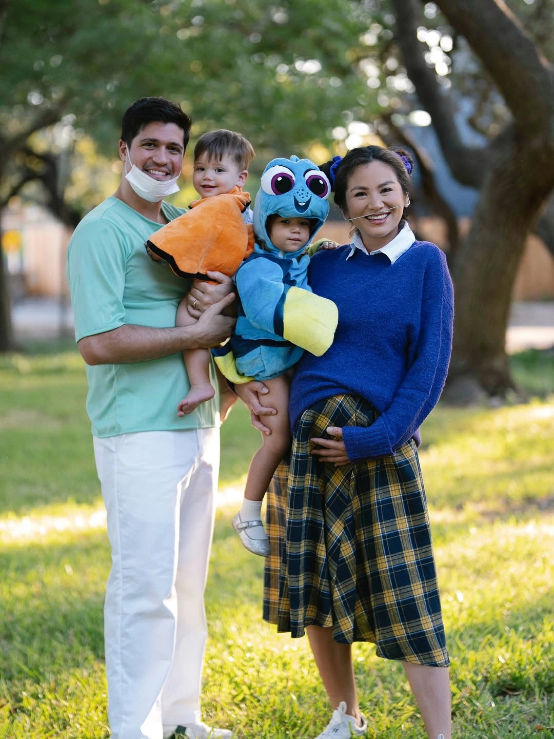 Parents in soft separates with children in blue and orange costumes