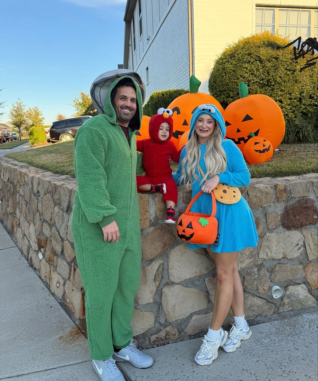 Family trio in green red and bright blue Halloween costumes
