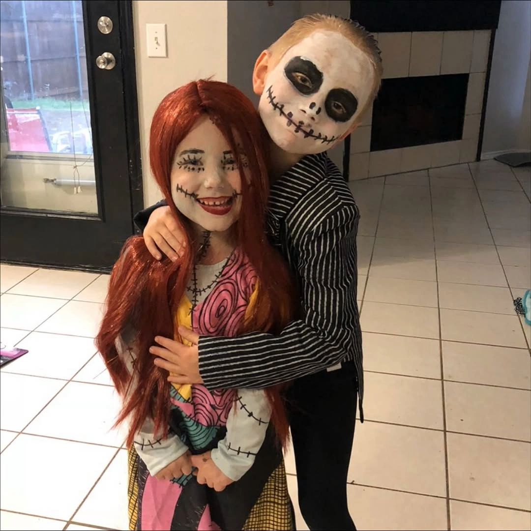 Red wig costume paired with black and white striped skeleton look