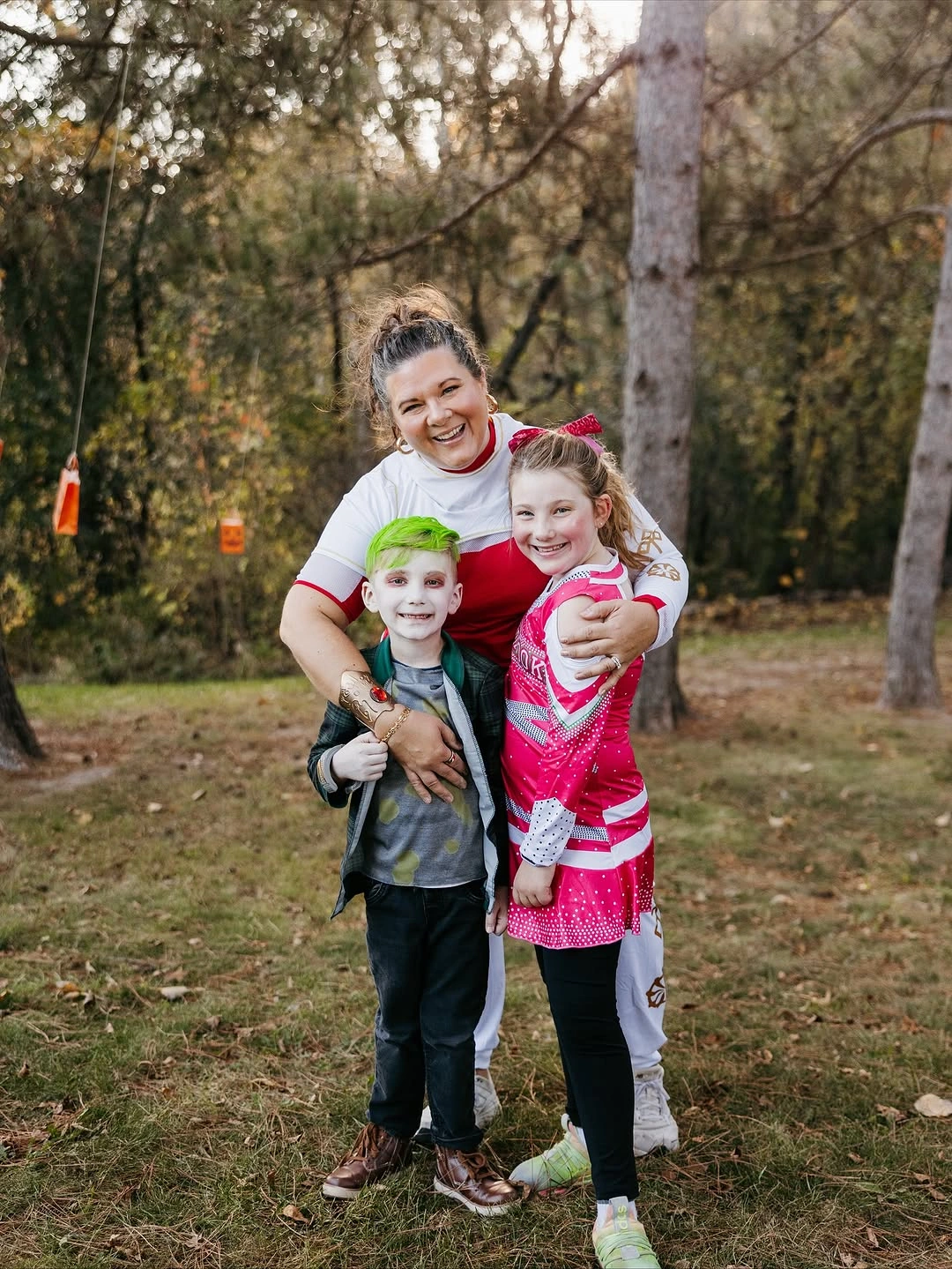 Family in casual character inspired costumes with green hair and bright prints