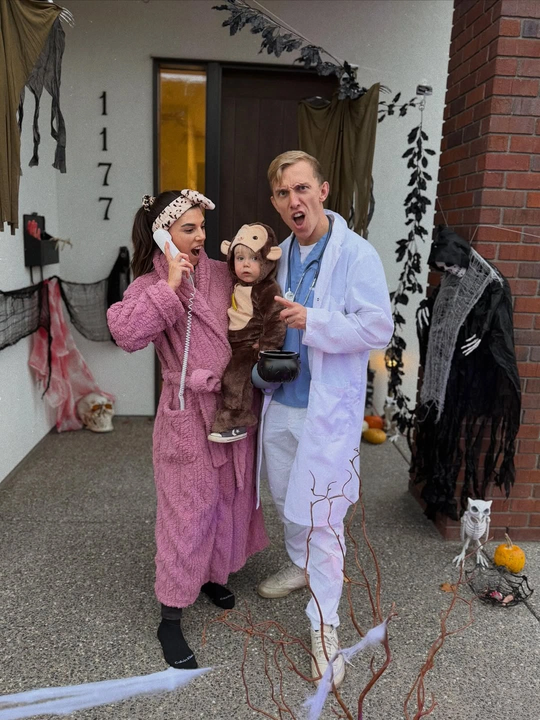 Family in pink brown and white plush graphic Halloween costumes