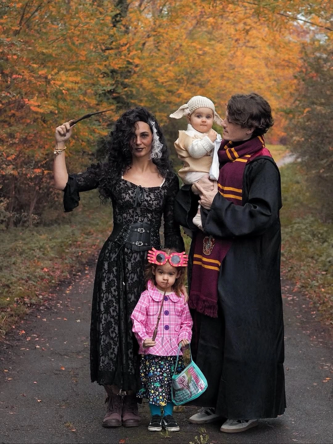 Dark storybook family costumes with a bright pink child outfit