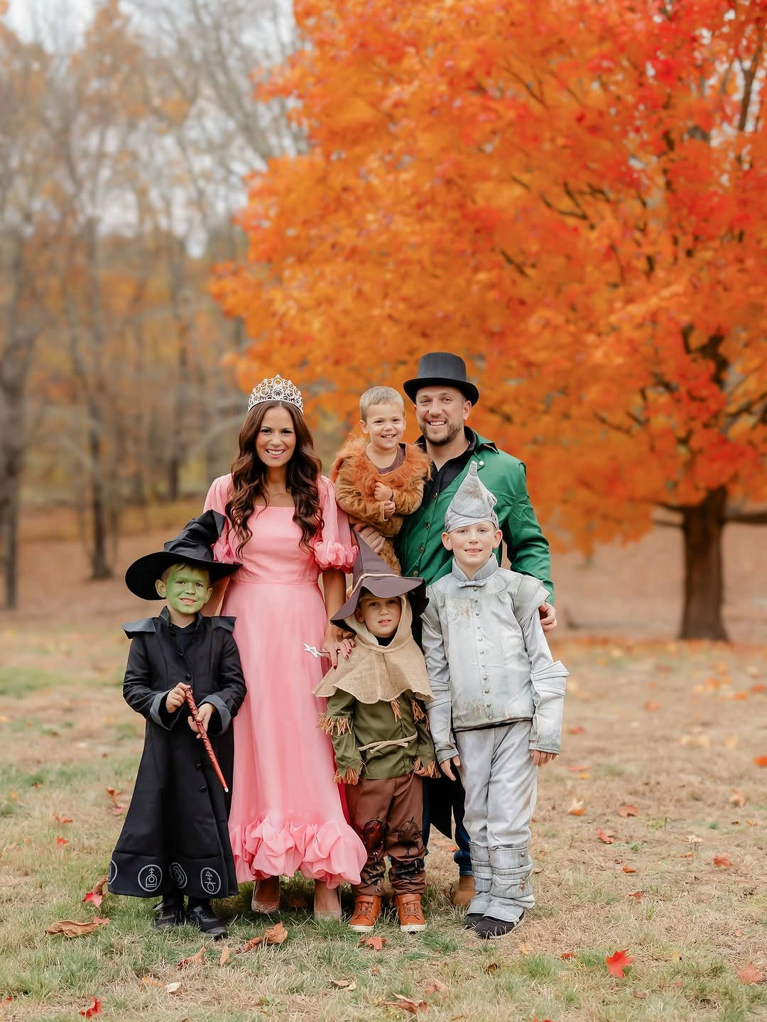 Large family group in pink green black tan and white costumes
