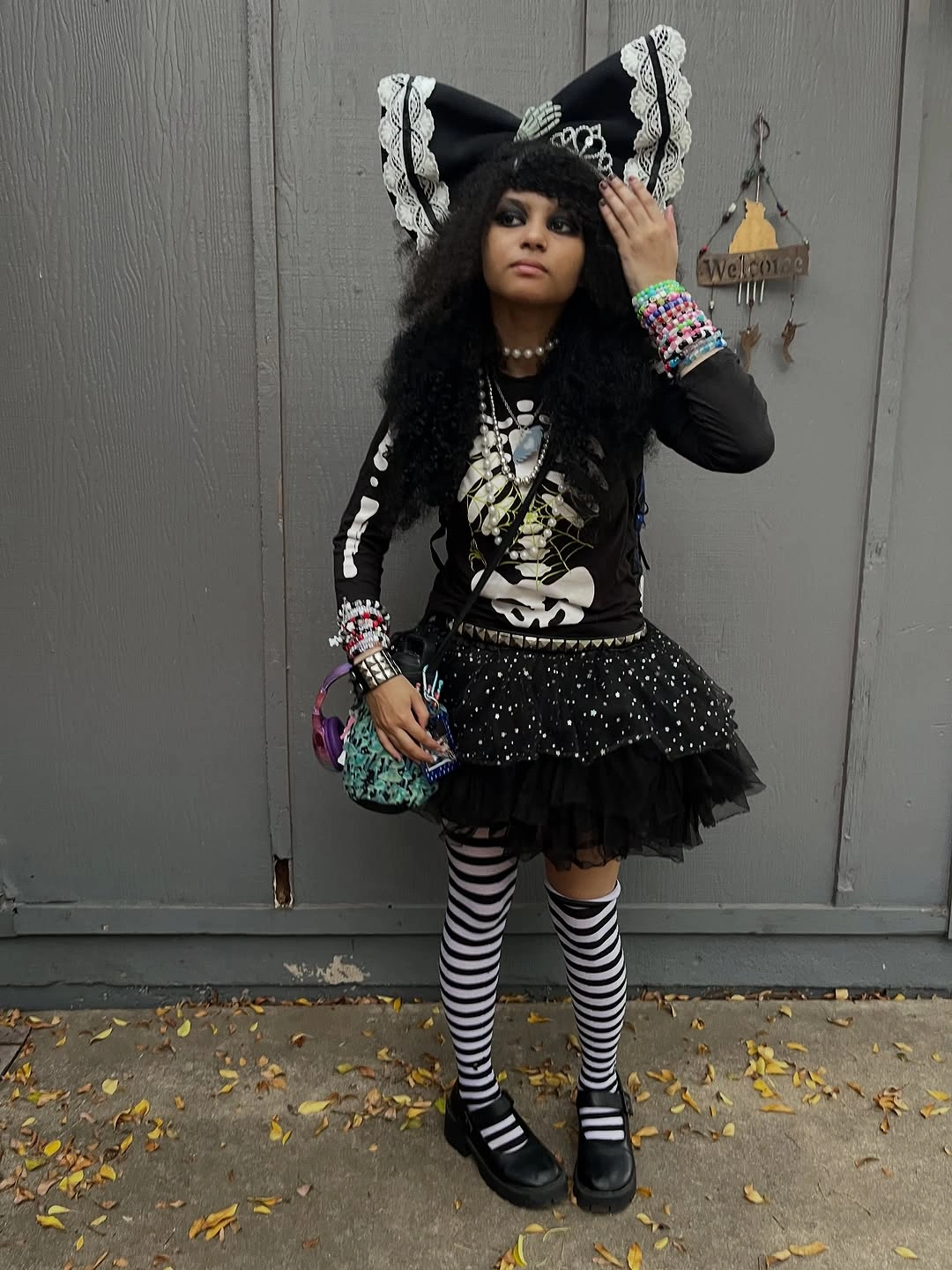 Black skeleton costume with striped tights layered skirt bow and black shoes