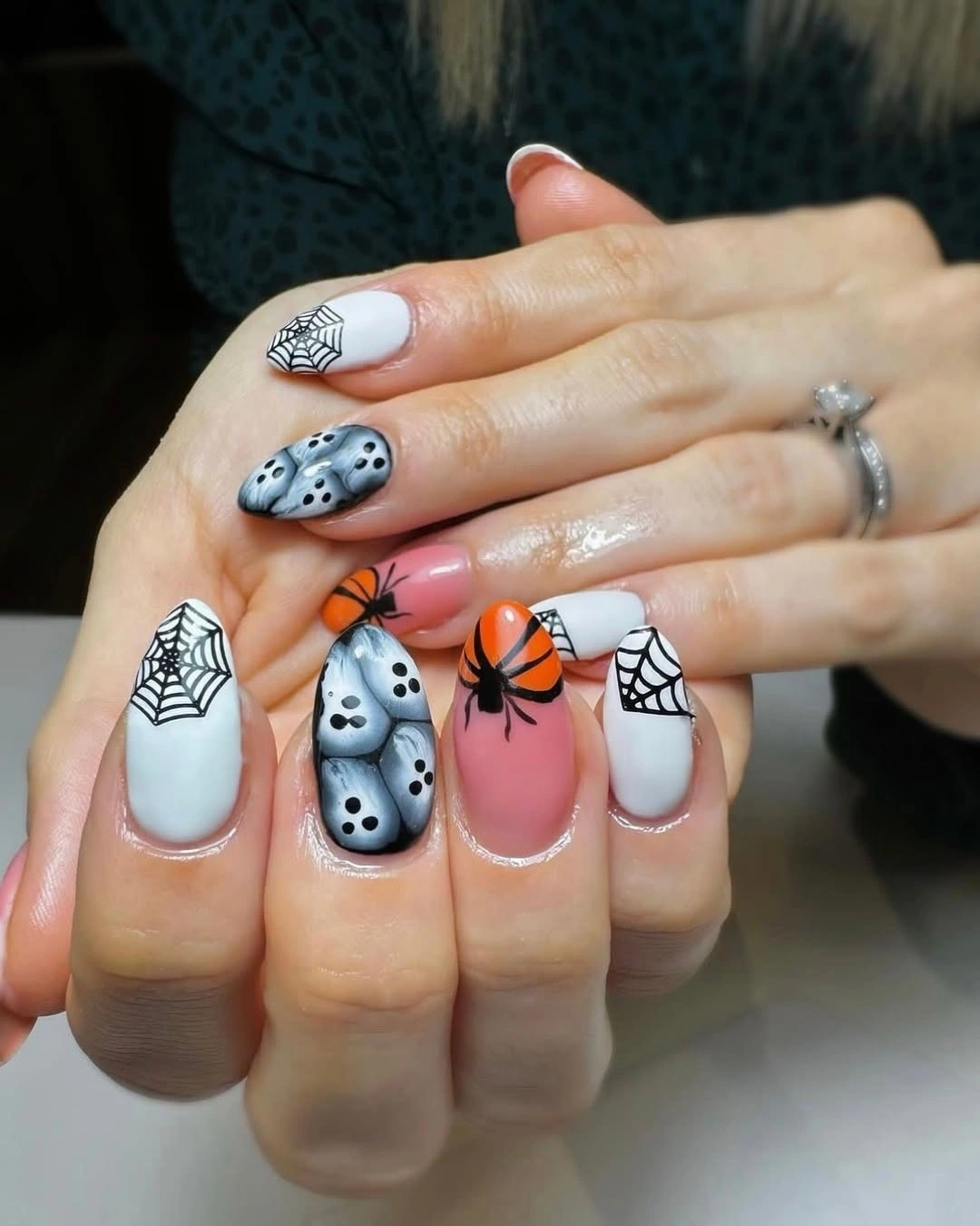 Short pastel nails with spiderwebs ghosts dots and soft blocks