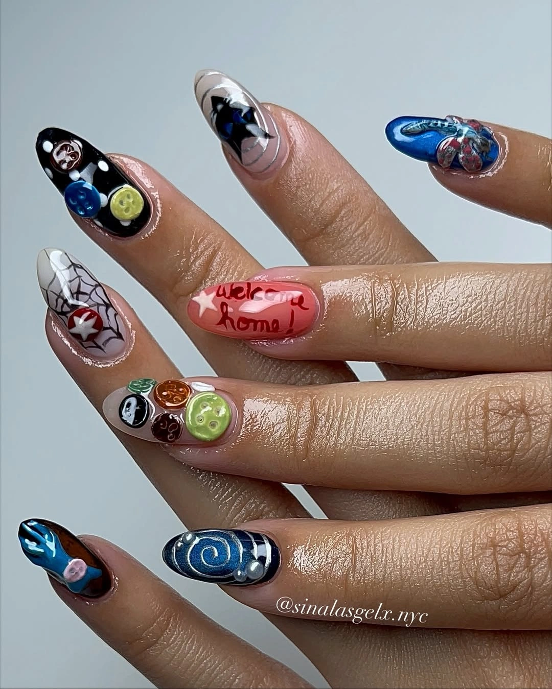 Long coffin nails with blue pink black and tiny Halloween icons