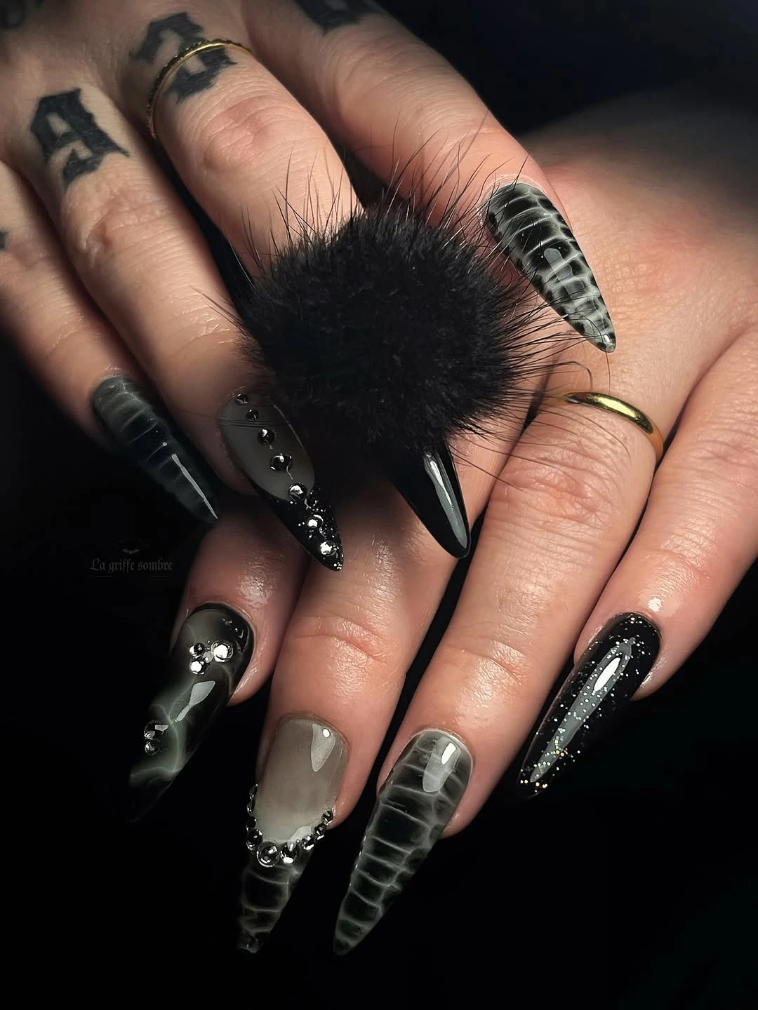 Long pointed black silver nails with metallic texture and studs