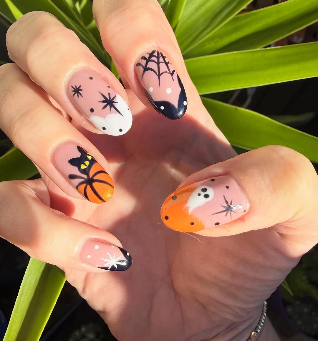 Medium almond nude orange nails with black bats and purple accents