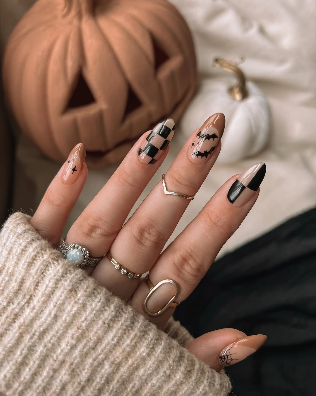 Long almond nude nails with brown plaid and black web accents