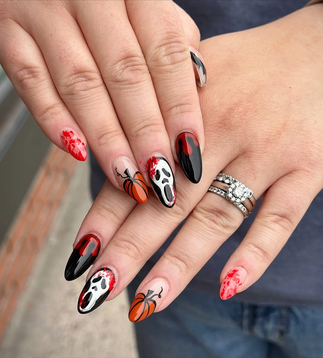 Long black red nude nails with orange pumpkins and white face detail