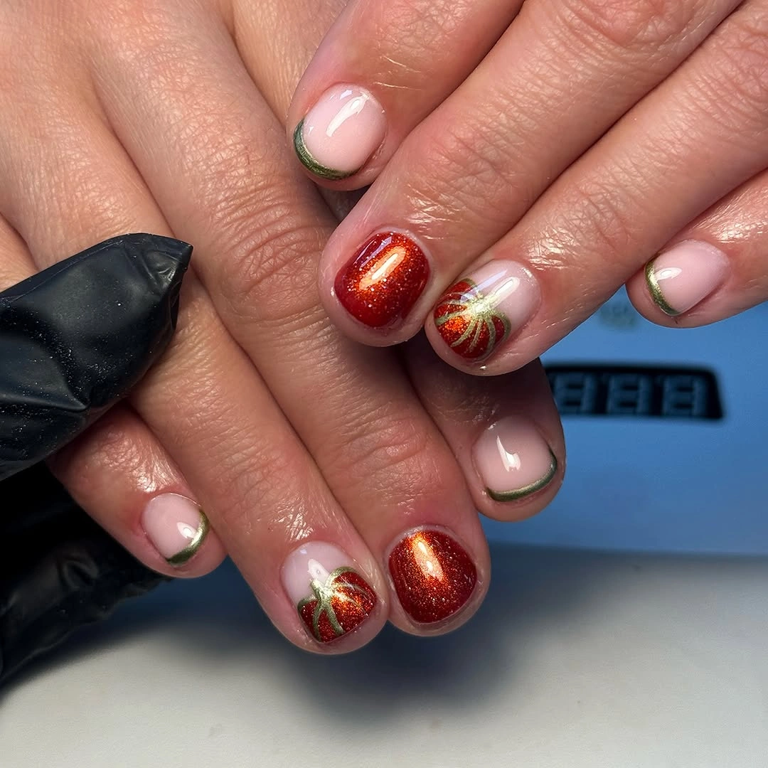 Short square nails with copper shimmer pumpkin art and nude negative space