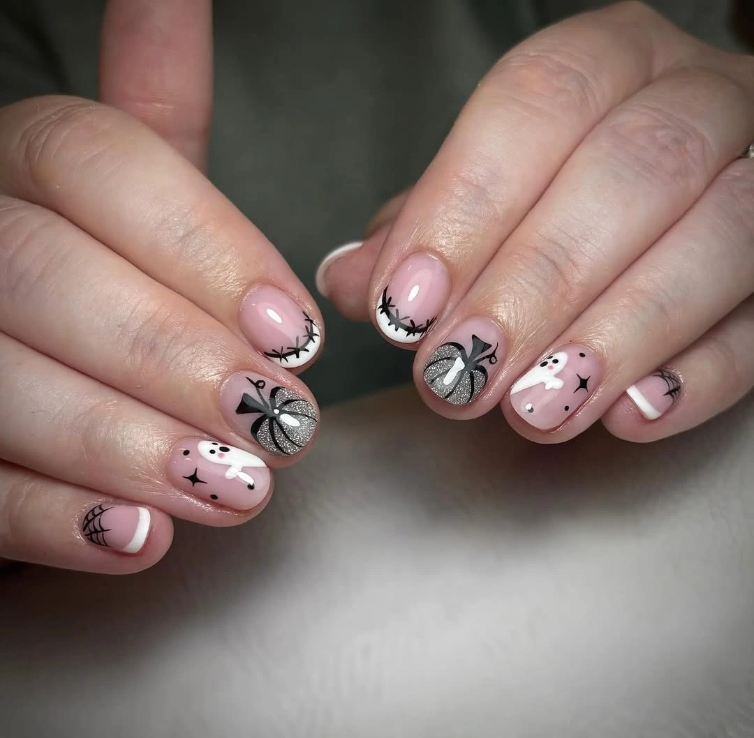 Soft pink nails with black bats white ghost gray web and fine art