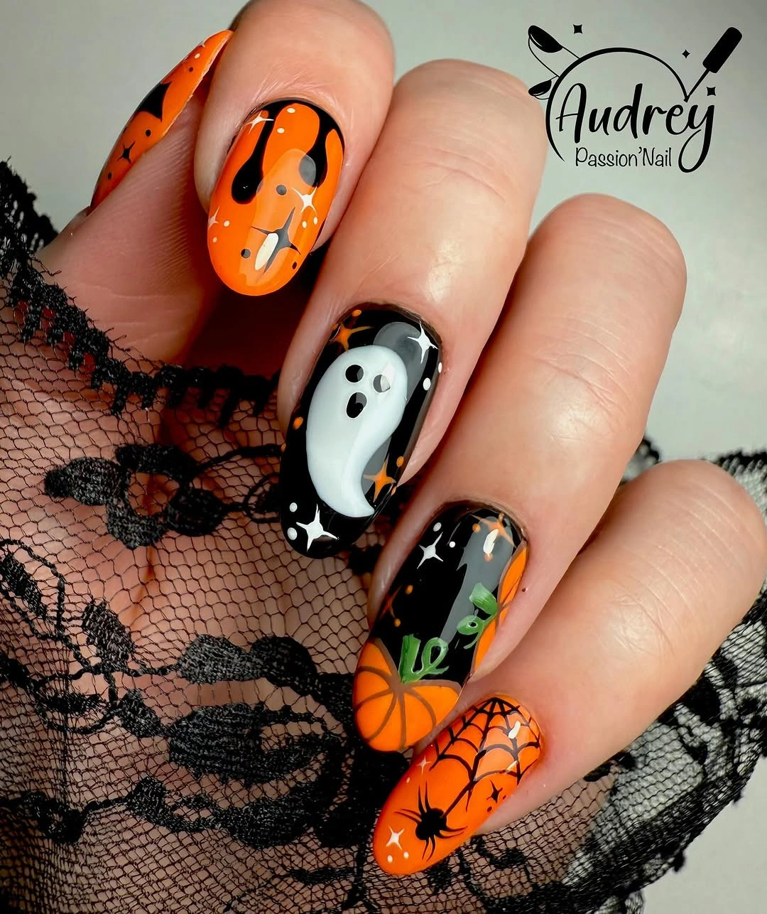 Long black and orange nails with ghost webs pumpkins and green detail
