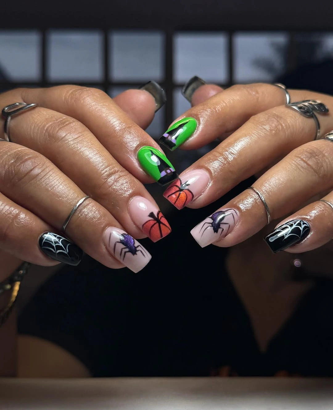 Long square nails with green black tips pumpkins webs and purple accents