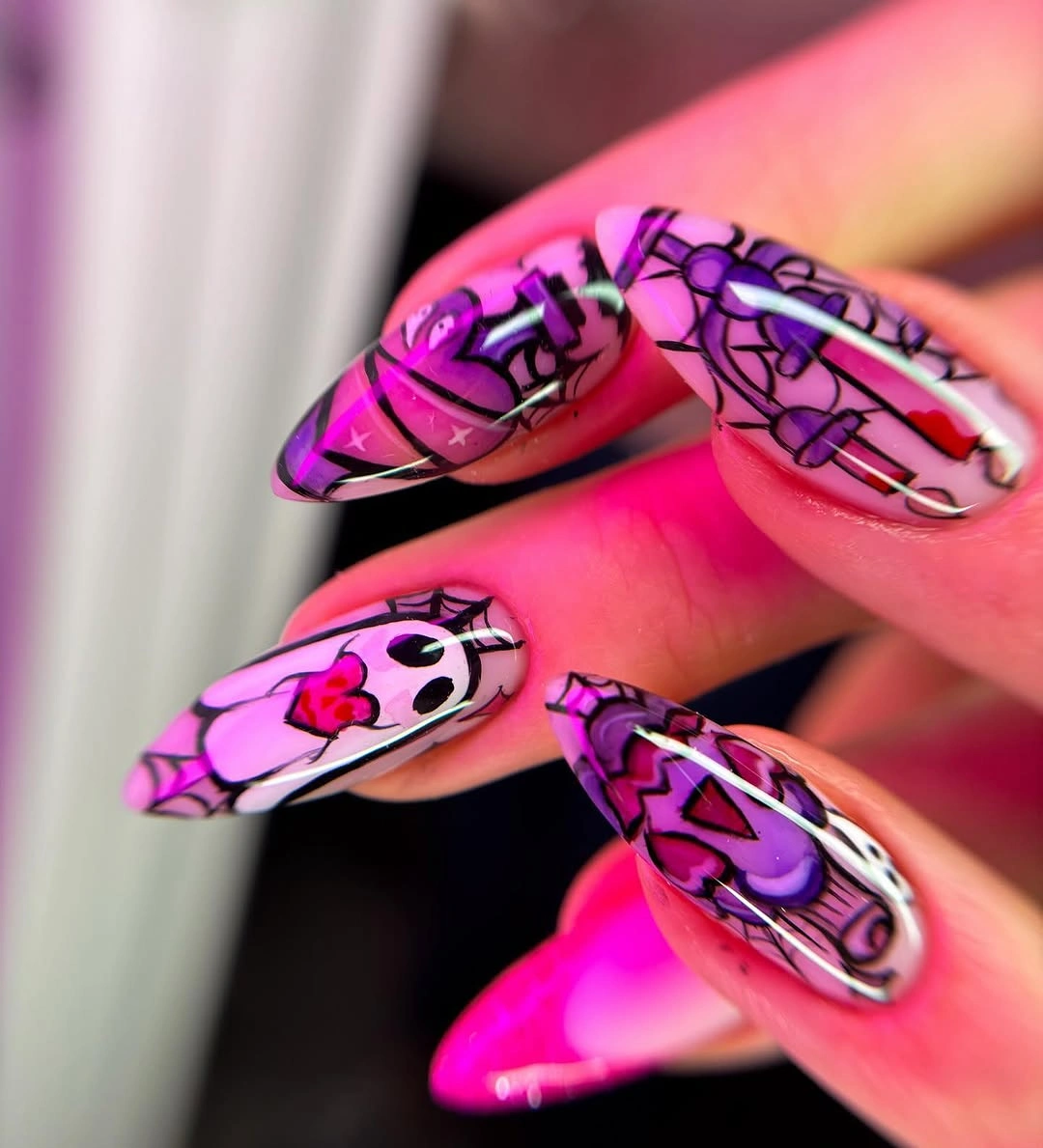 Very long neon pink purple nails with spooky cartoon artwork