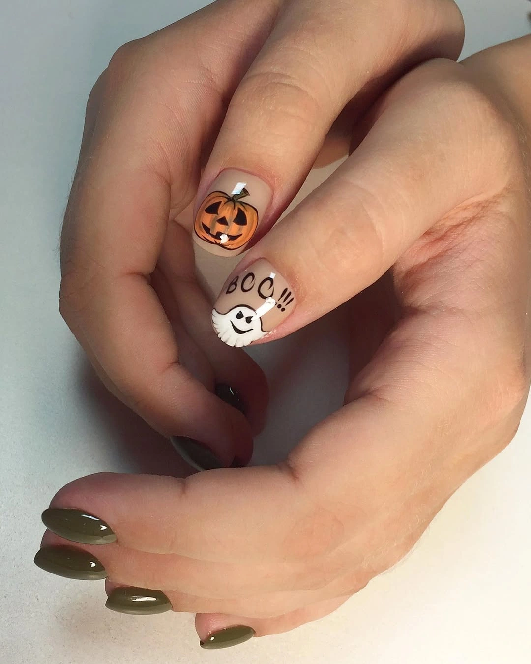 Medium almond pink white nails with ghost faces and olive accent