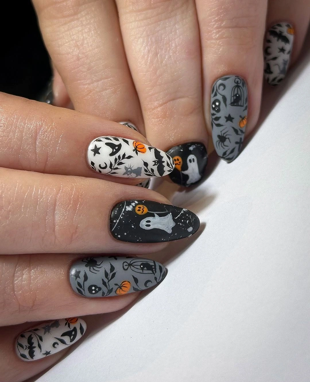 Medium almond white gray nails with black spooky illustrations