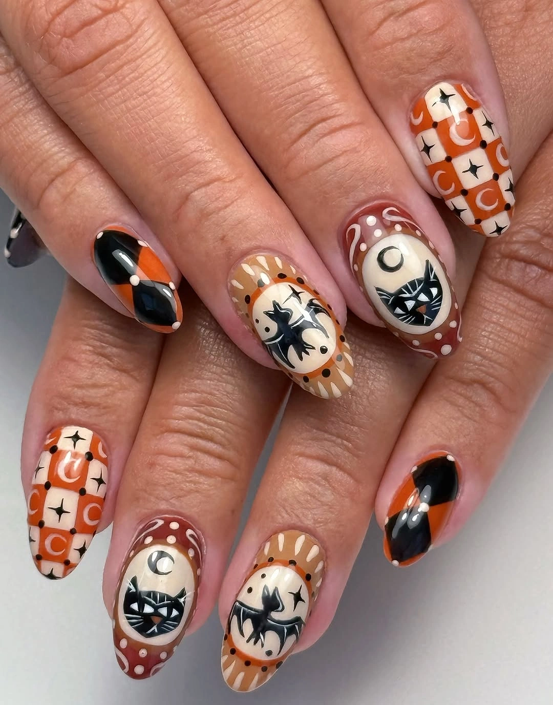 Medium almond orange white black nails with comic Halloween motifs
