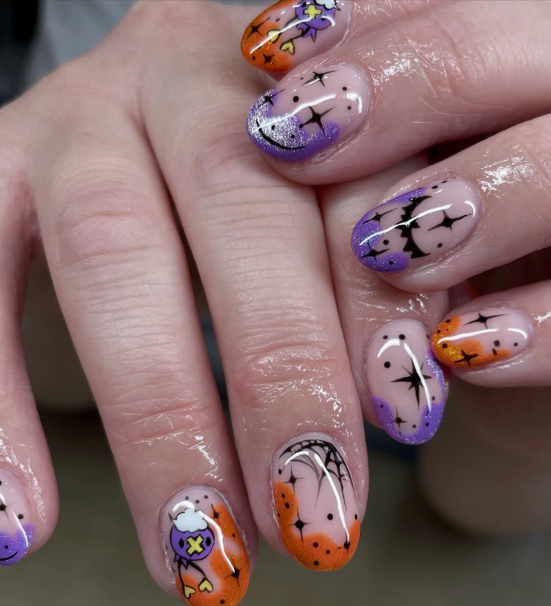 Medium almond lavender nails with orange and purple seasonal icons