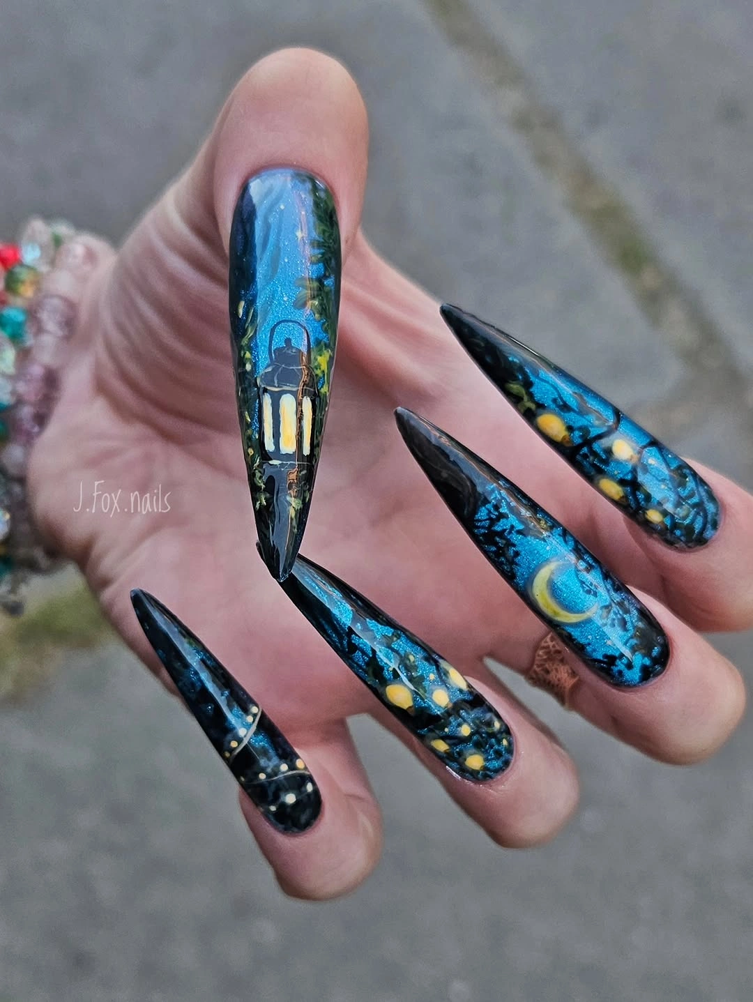 Very long blue black coffin nails with colorful marbled details