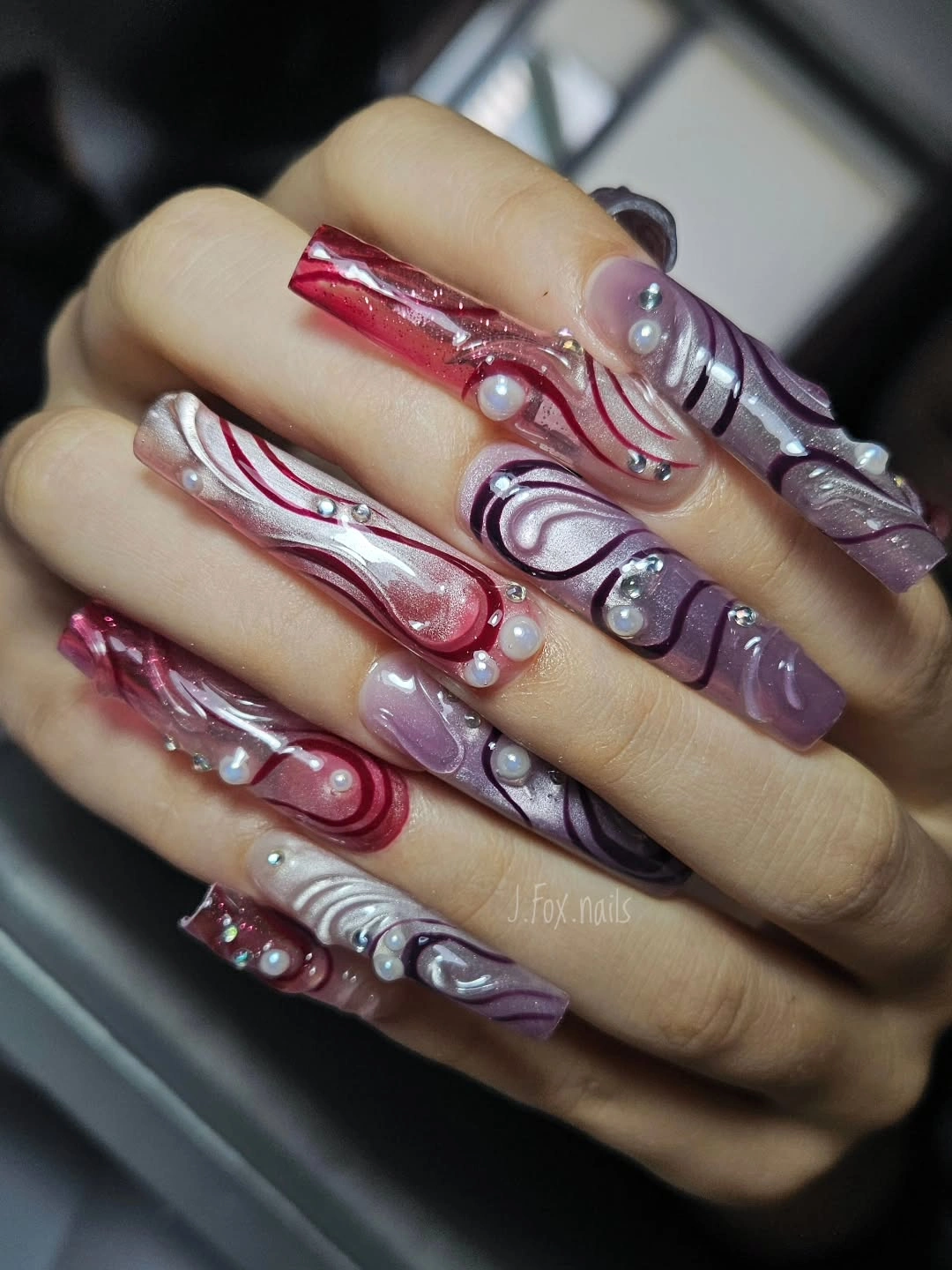 Long coffin mauve nails with silver red raised swirl details