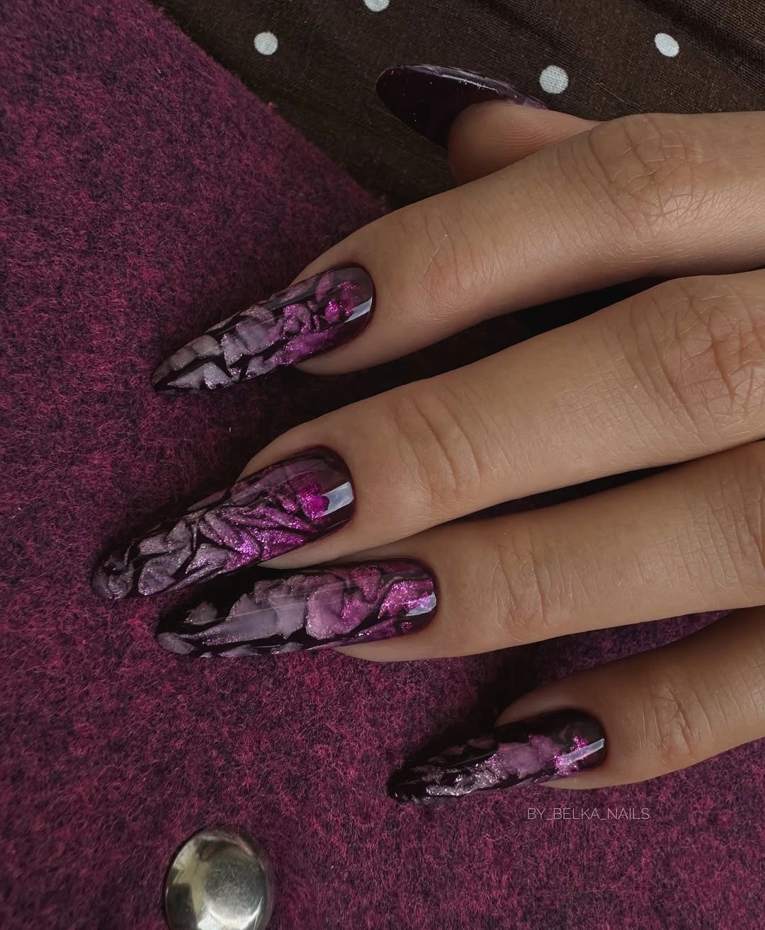 Long pointed purple black nails with flowing marbled patterning