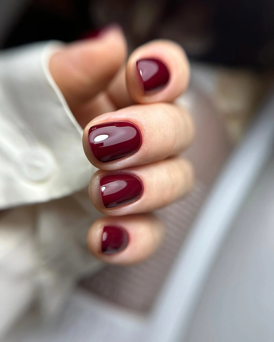 Short rounded square nails in a smooth glossy deep burgundy shade