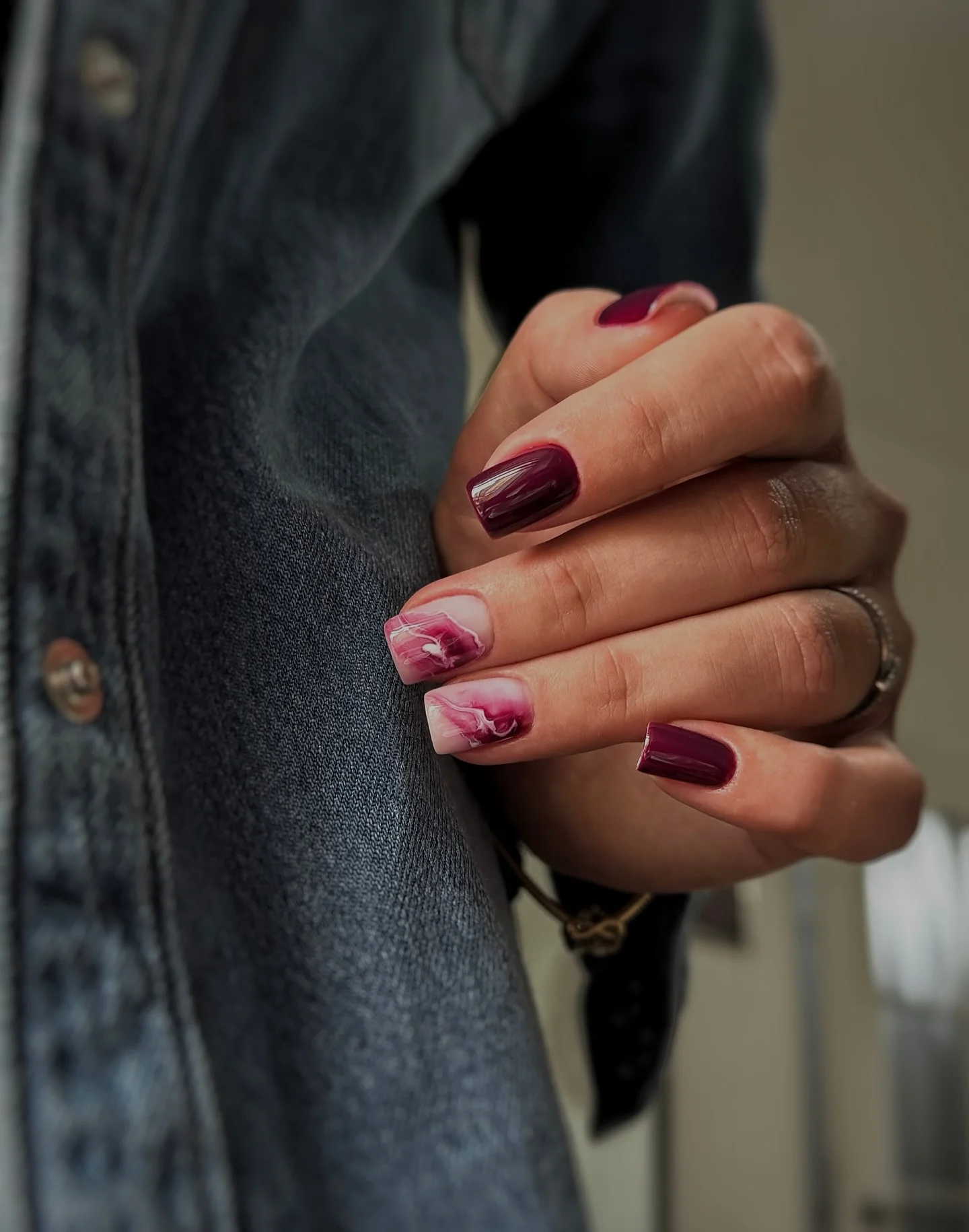 Short burgundy squoval nails with soft pink burgundy marble accents