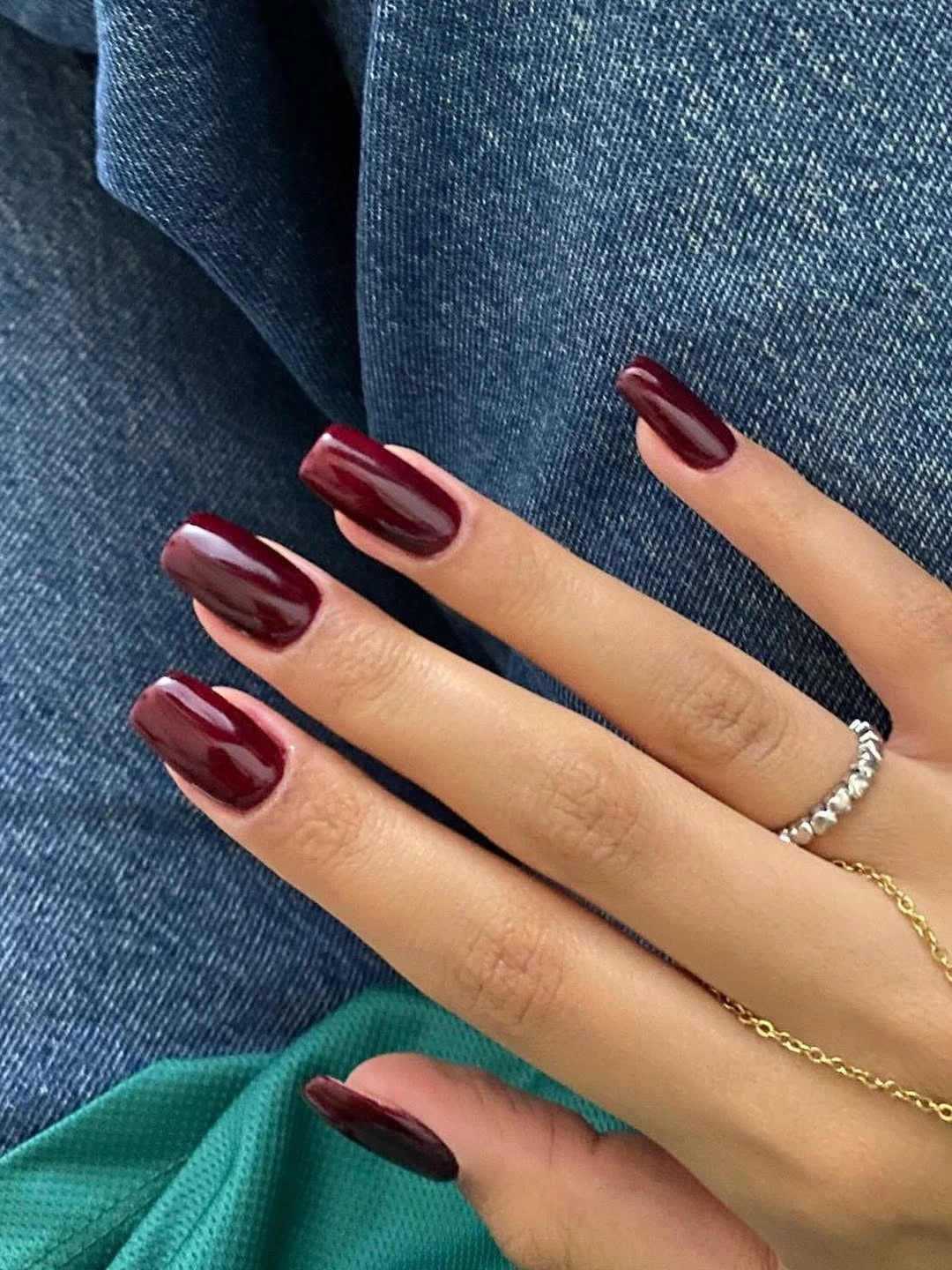 Long glossy square nails in wine burgundy with strong vertical reflections