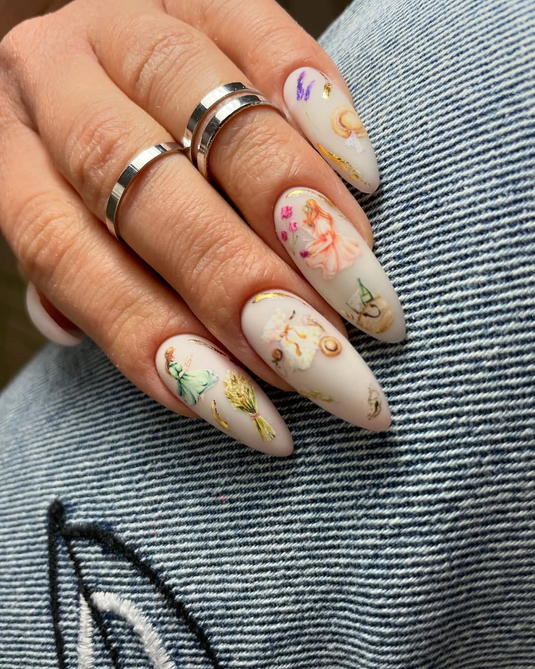 Ivory almond nails with multicolored small hand-painted floral illustrations