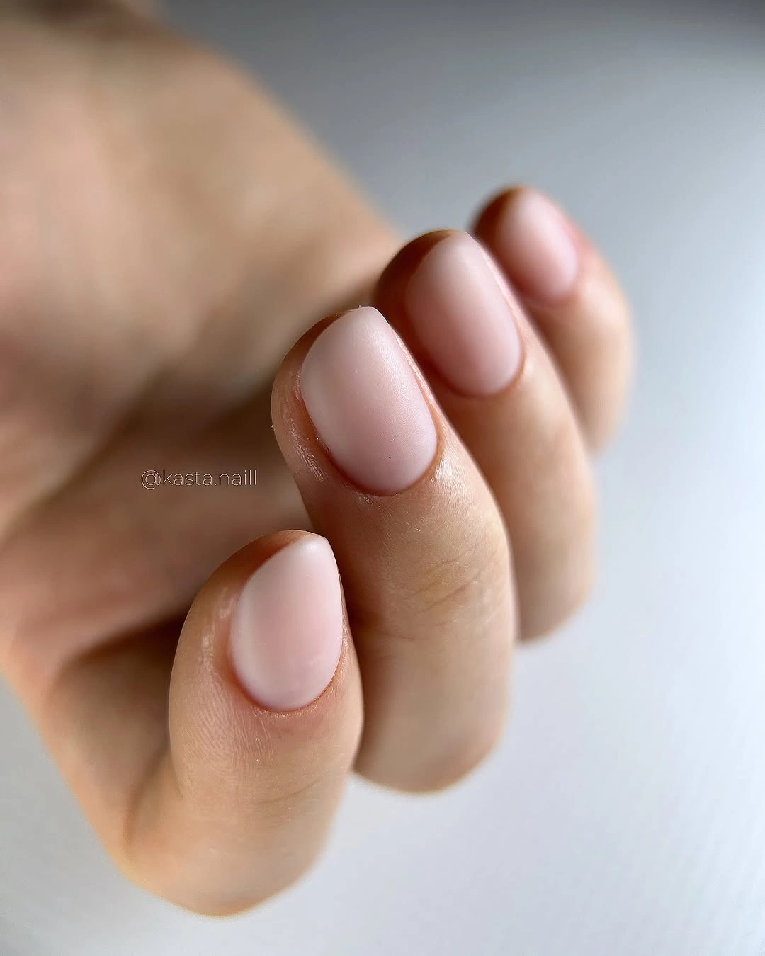 Short rounded square nails in a uniform pale blush matte finish