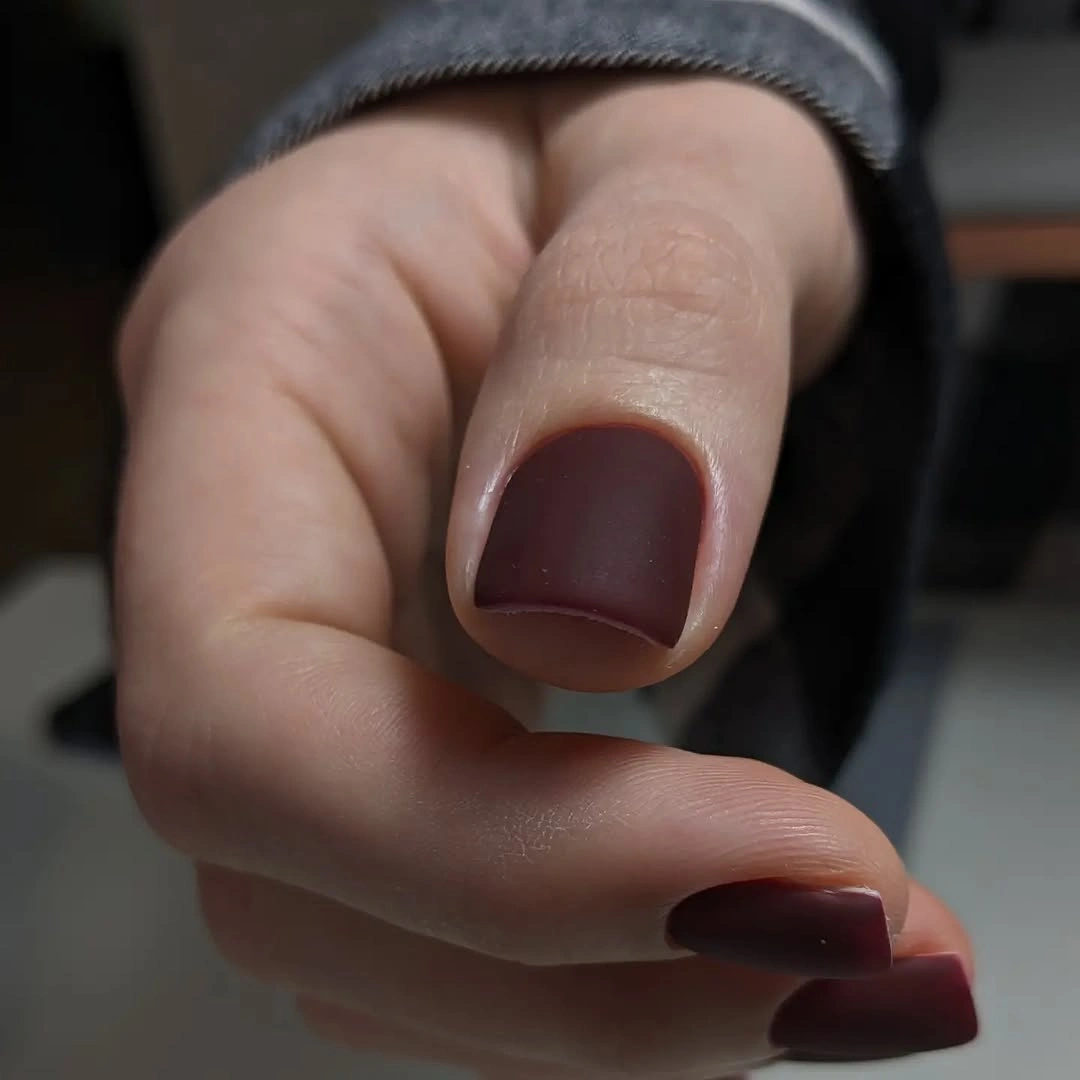 Short rounded square nails in a deep cocoa brown matte color