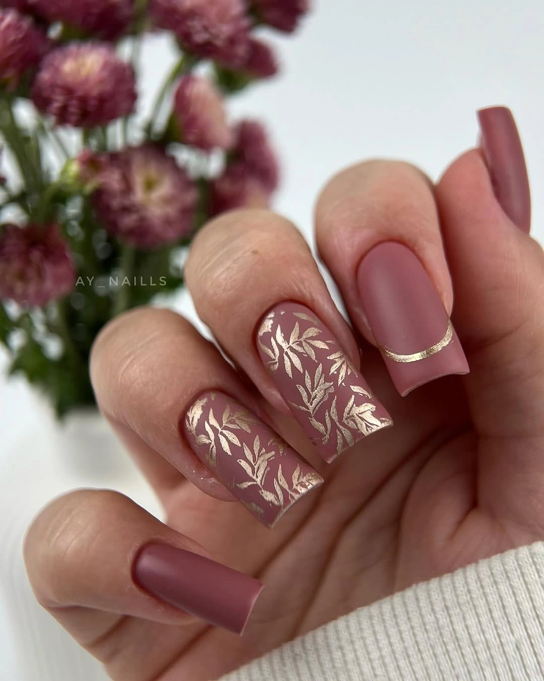 Dusty mauve matte square nails with delicate pale leaf accents