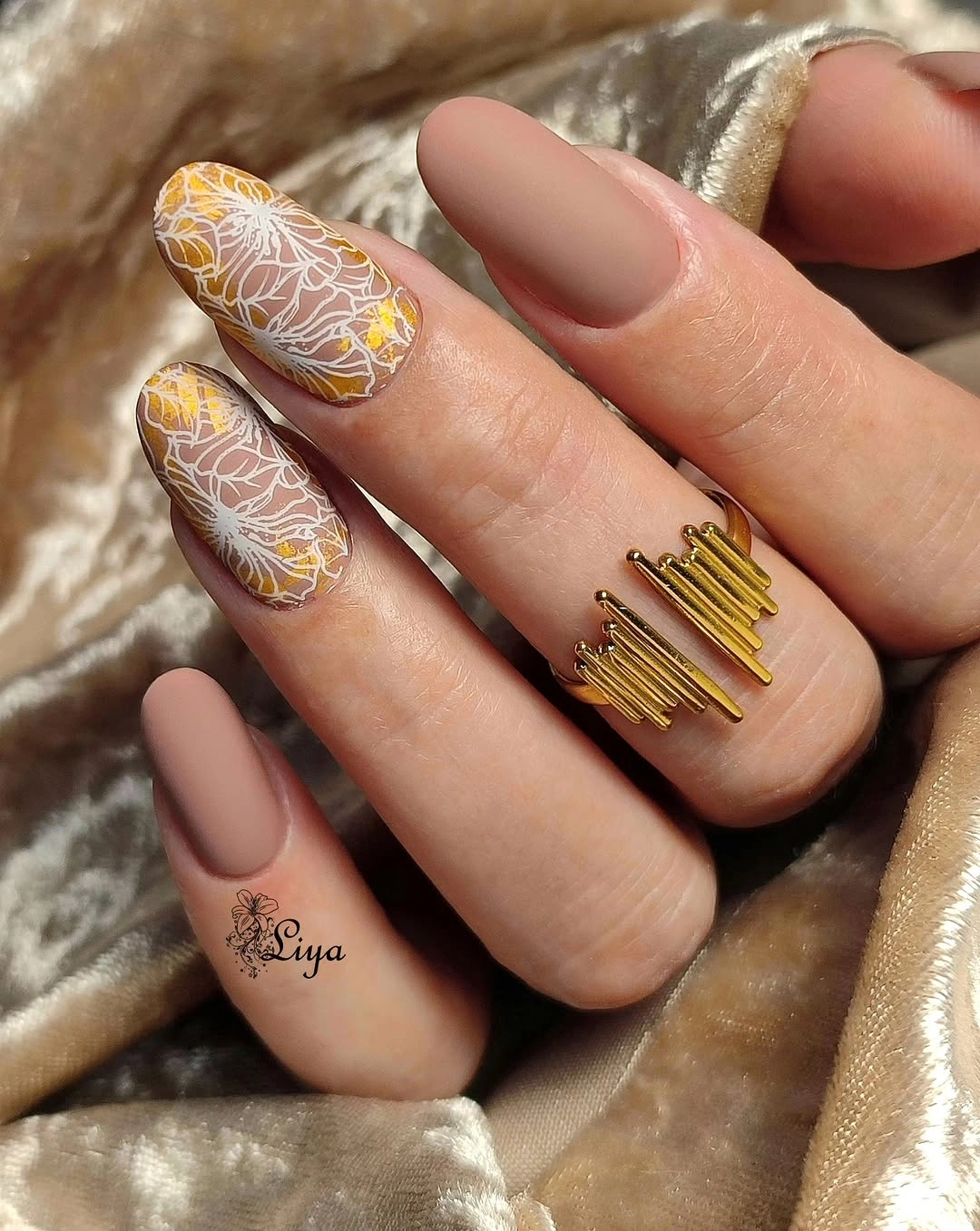 Taupe matte almond nails with ocher botanical linework accents