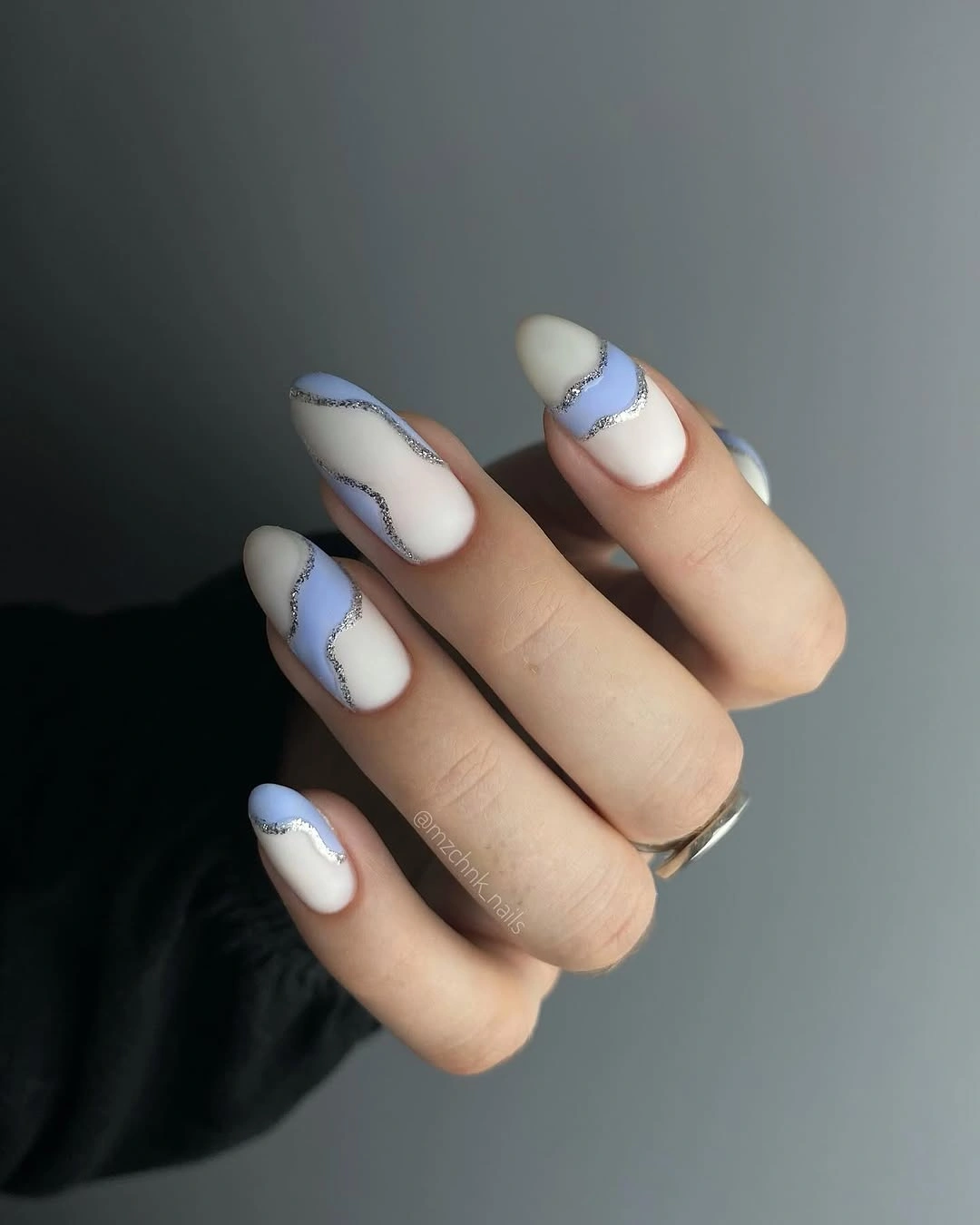Matte ivory almond nails with pale blue wavy French edges