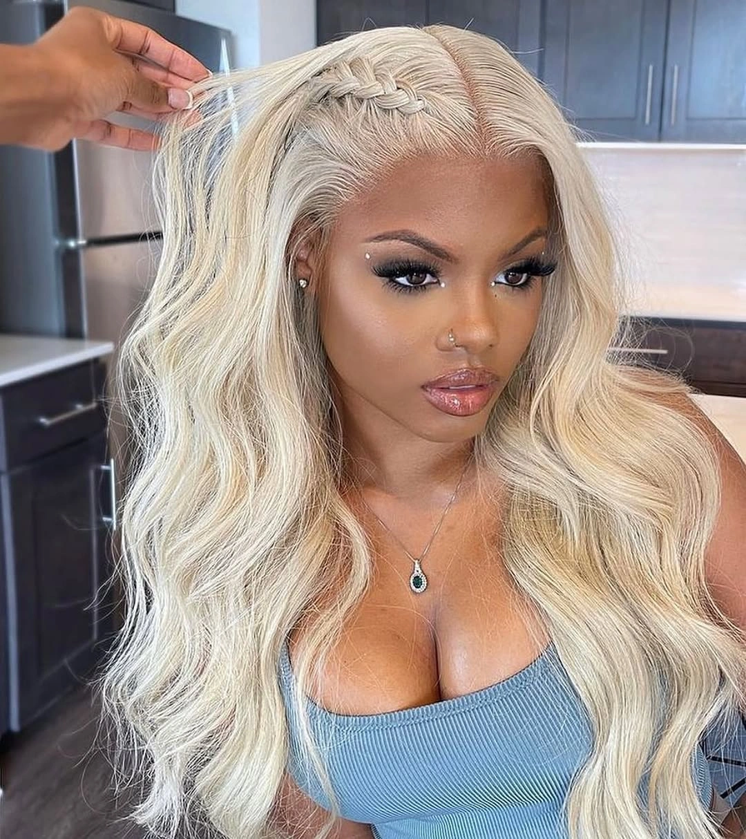 Long pale blonde center-parted waves with a narrow front braid detail