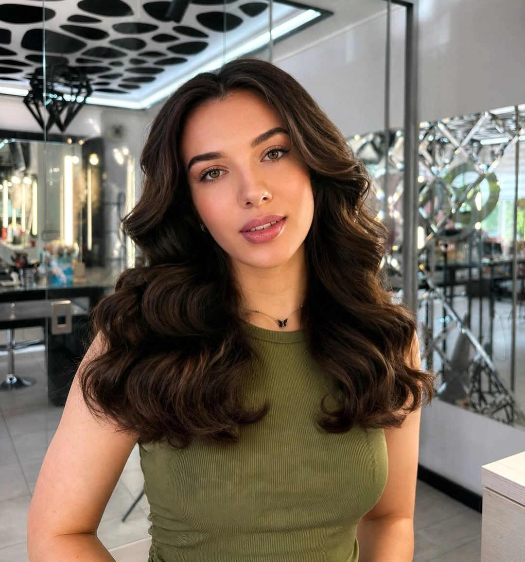 Medium brunette center-parted hair with soft waves and rounded ends