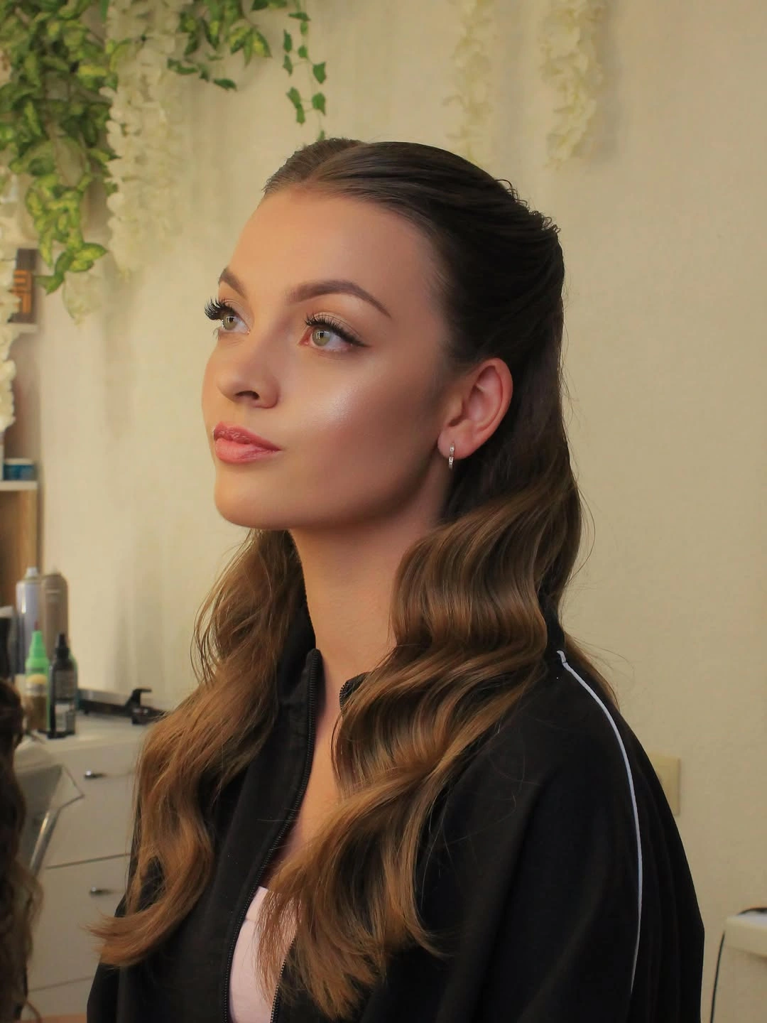 Brown center-parted hair with a controlled front and loose lower waves
