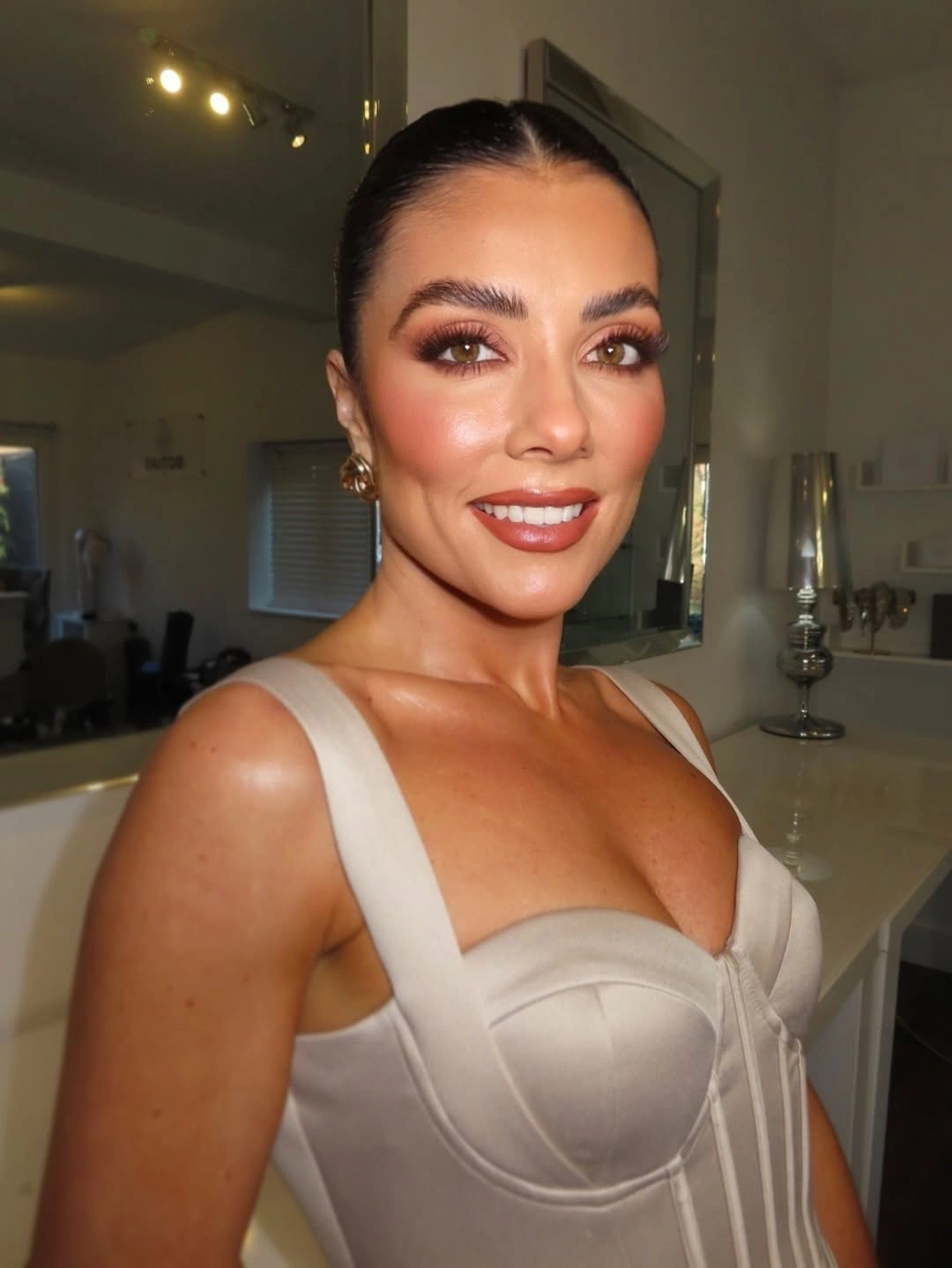 Sleek center-parted hair smoothed back from the face