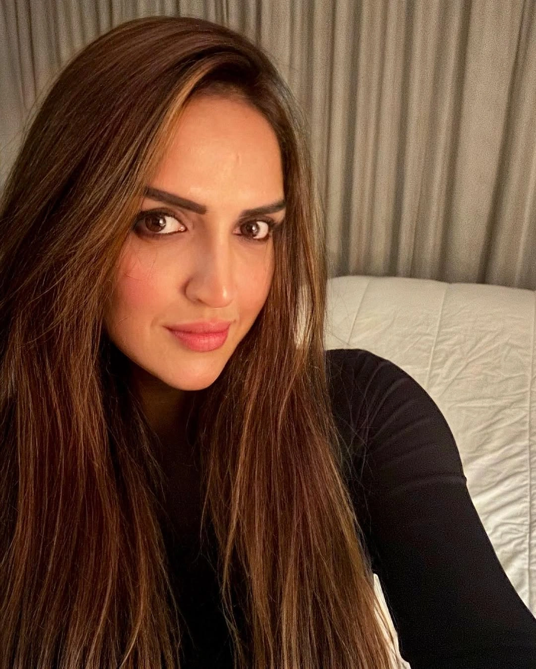 Very long brown center-parted hair with subtle bends at the ends