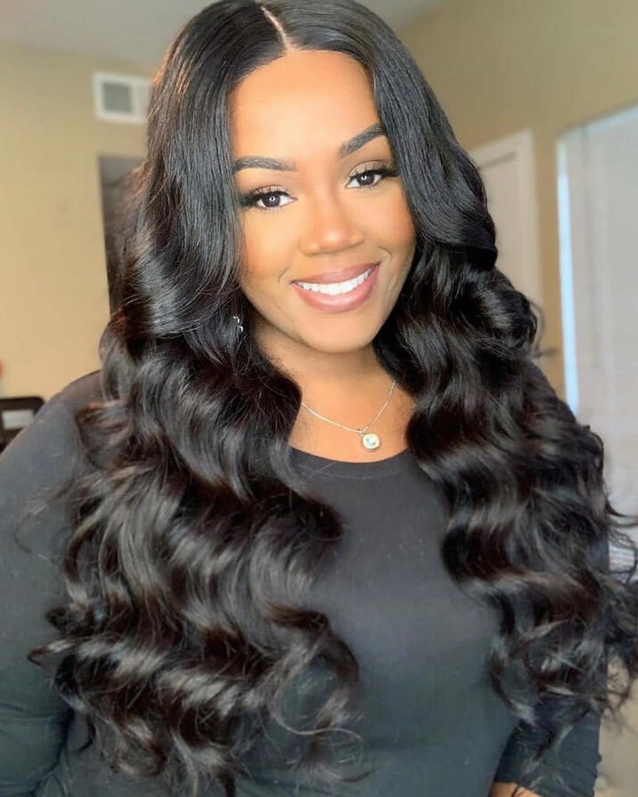 Long black center-parted hair with broad brushed waves