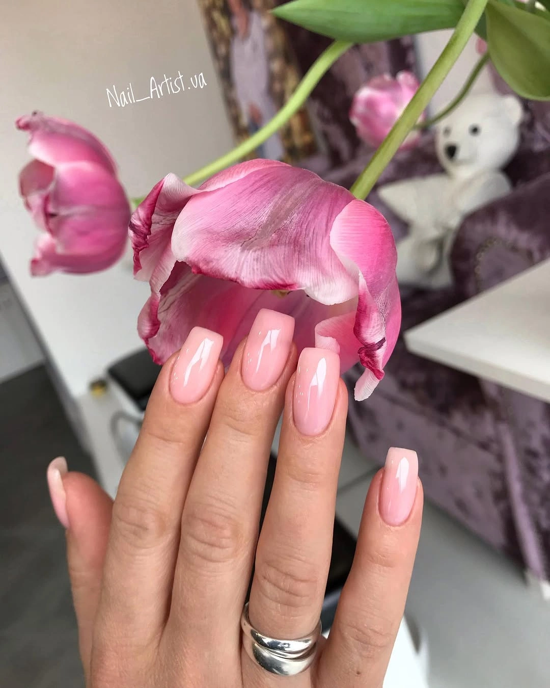 Long square nails in glossy soft pink polish