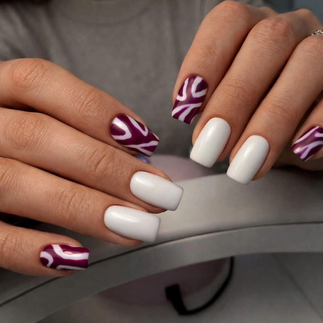 Medium white square nails with deep plum wave accents