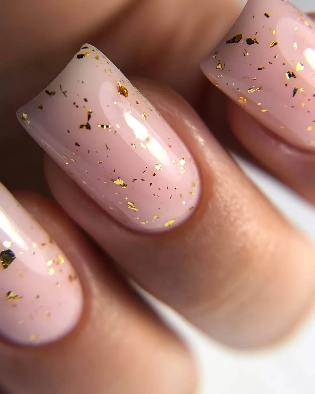 Medium pink nude square nails with scattered gold foil