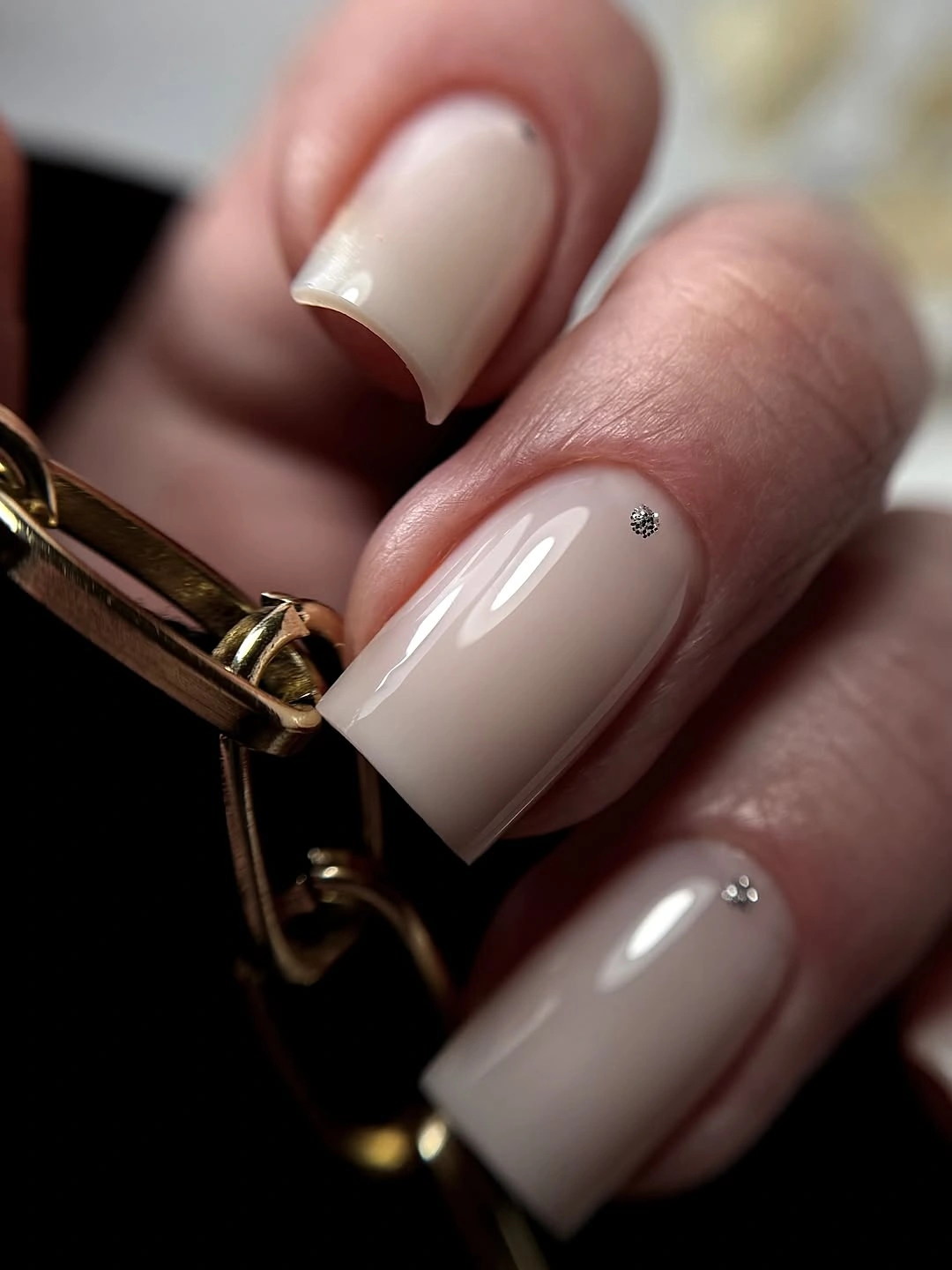 Short creamy French square nails with one tiny silver jewel
