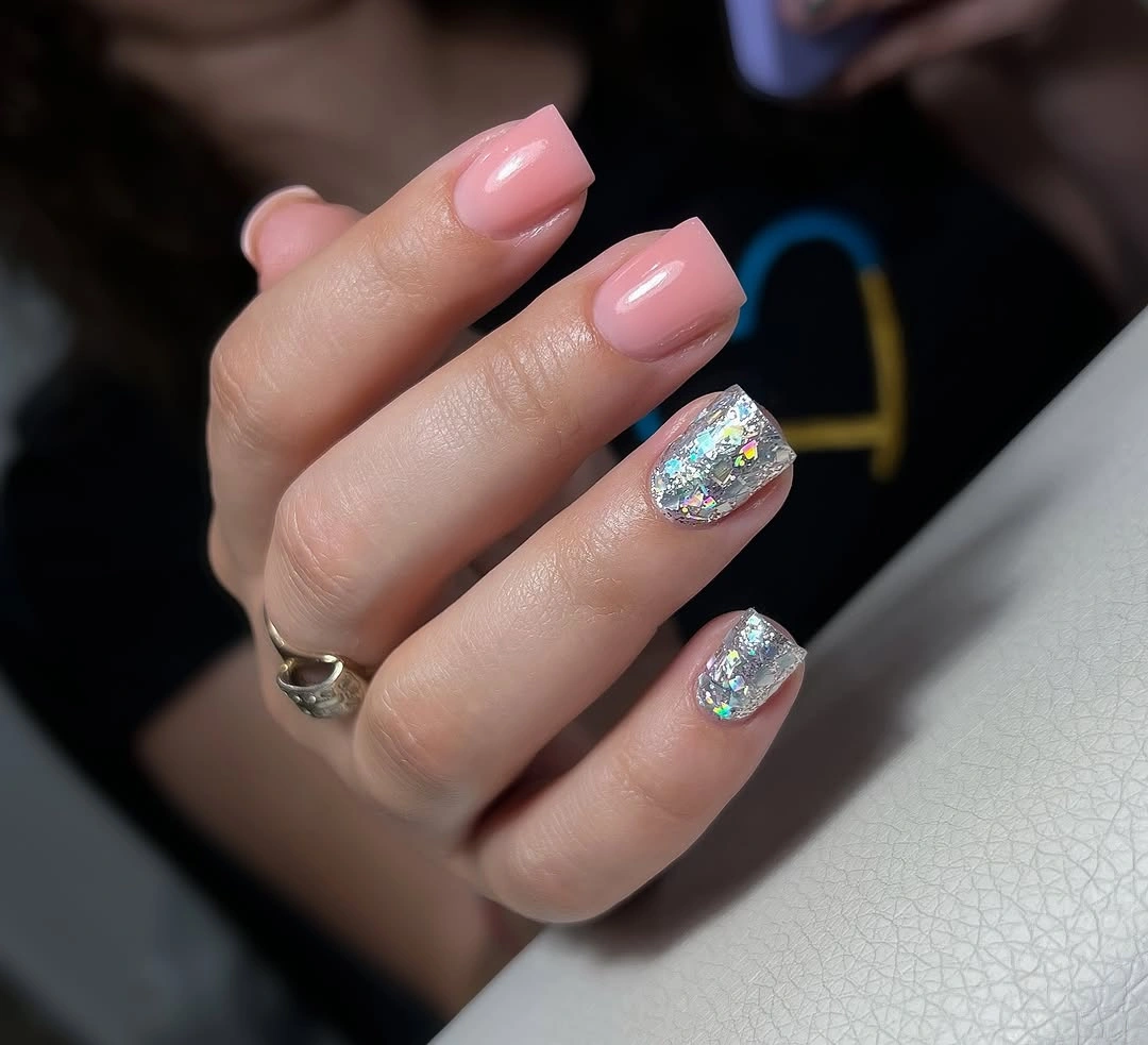 Long blush almond nails with two silver glitter accents